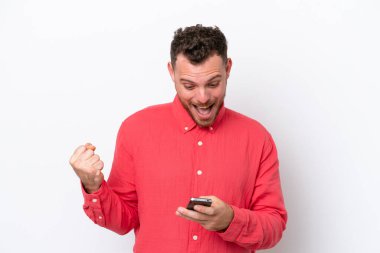 Beyaz arka planda izole edilmiş genç Brezilyalı bir adam şaşırdı ve bir mesaj gönderiyor.