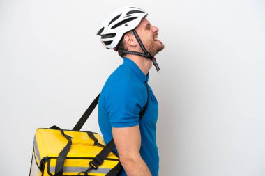 Termal sırt çantalı genç Brezilyalı adam beyaz arka planda izole edilmiş. Yan pozisyonda gülüyor.