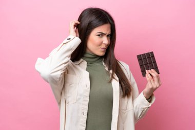 Pembe arka planda çikolatalı genç Brezilyalı kadın kuşkuları var.