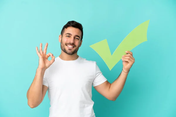 Young Handsome Caucasian Man Isolated Blue Background Holding Check Icon — Zdjęcie stockowe