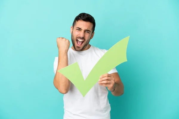 Young Handsome Caucasian Man Isolated Blue Background Holding Check Icon — Stock fotografie