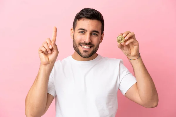 Young Man Holding Bitcoin Isolated Pink Background Pointing Great Idea — 스톡 사진