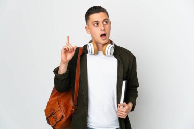Young caucasian student man isolated on white background thinking an idea pointing the finger up