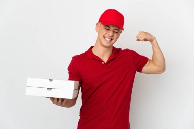 Pizza delivery man with work uniform picking up pizza boxes isolated on white background doing strong gesture