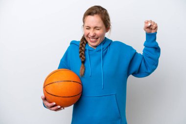 Beyaz arka planda basketbol oynayan beyaz bir kadın güçlü bir jest yapıyor.