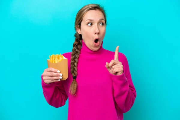 Young Caucasian Woman Holding Fried Chips Isolated Blue Background Thinking — Stock fotografie