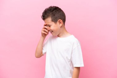 Little caucasian boy isolated on pink background laughing