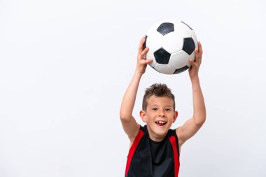 Boy playing football over isolated white wall