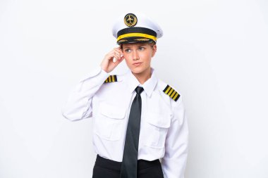 Beyaz arka planda izole edilmiş Kafkasyalı kadın uçak pilotu şüpheleri var ve kafası karışmış bir yüz ifadesi var.