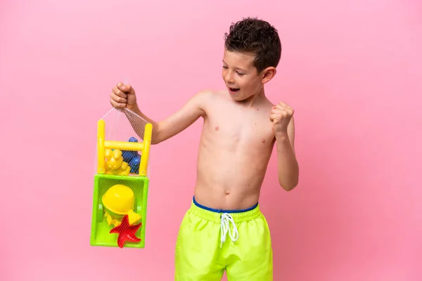 Little Caucasian Boy Holding Beach Toys Isolated Pink Background Celebrating — Stok fotoğraf