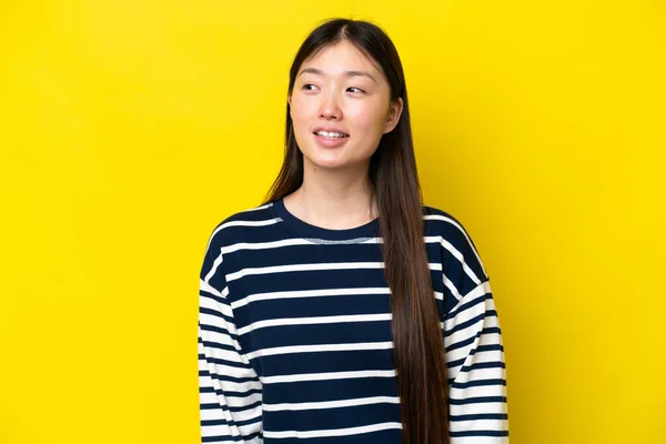 Jonge Chinese Vrouw Geïsoleerd Gele Achtergrond Kijken Naar Zijkant Glimlachen — Stockfoto