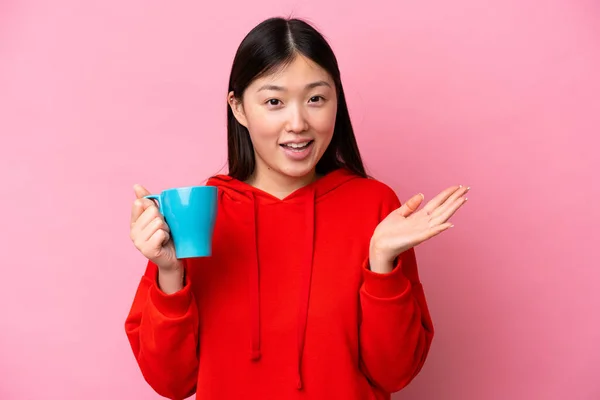 Νεαρή Κινέζα Γυναίκα Κρατώντας Φλιτζάνι Καφέ Απομονώνονται Ροζ Φόντο Σοκαρισμένη — Φωτογραφία Αρχείου
