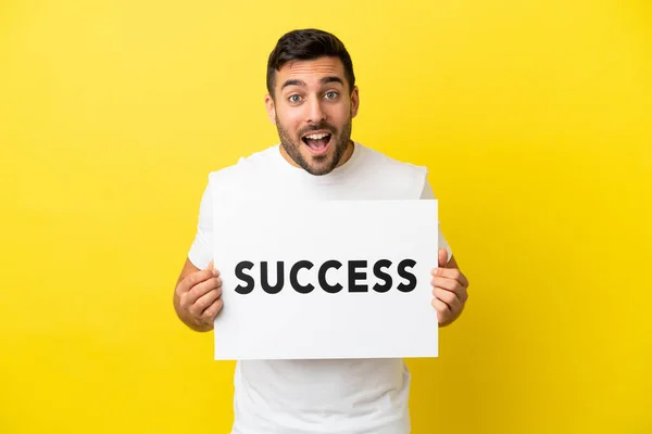 Young Handsome Caucasian Man Isolated Yellow Background Holding Placard Text — Φωτογραφία Αρχείου