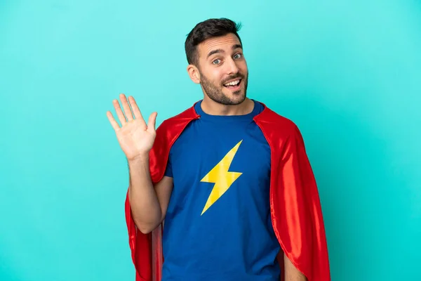 Super Hero Caucasian Man Isolated Blue Background Saluting Hand Happy — Stock fotografie