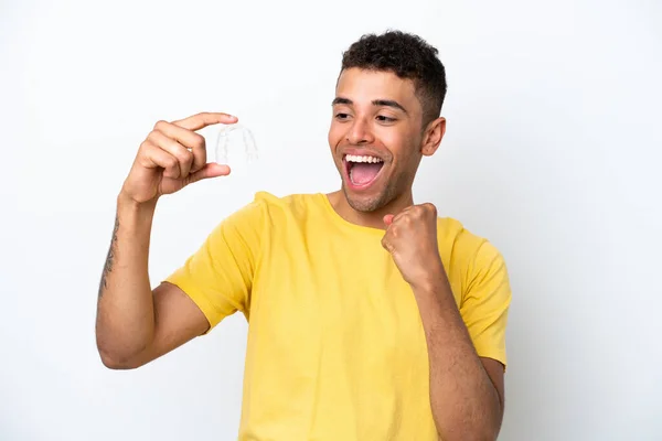 Young Brazilian Man Holding Invisible Braces Isolated White Background Celebrating — 스톡 사진