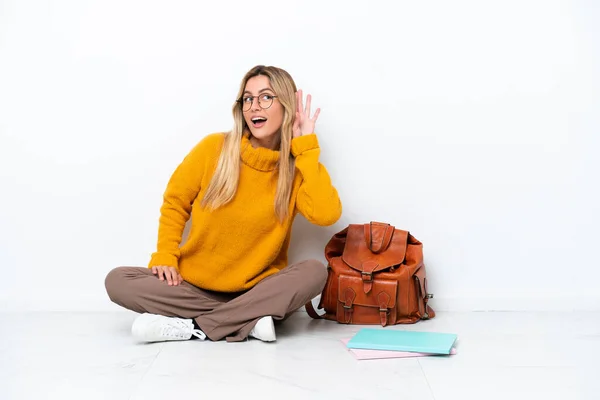 Uruguayan Student Woman Sitting One Floor Isolated White Background Listening — стоковое фото