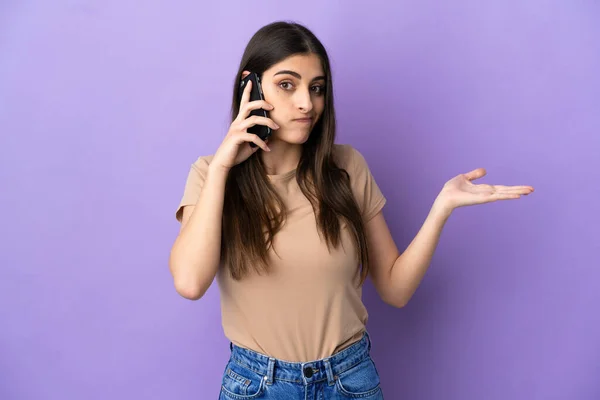 Young Caucasian Woman Using Mobile Phone Isolated Purple Background Having — стоковое фото