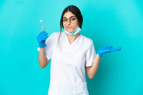 Young Caucasian Dentist Woman Holding Tools Isolated Blue Background Having — Zdjęcie stockowe