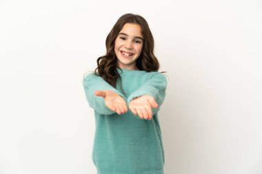 Beyaz arka planda izole edilmiş küçük beyaz kız bir ilan vermek için avucunun içinde hayali bir fotokopi makinesi tutuyor.