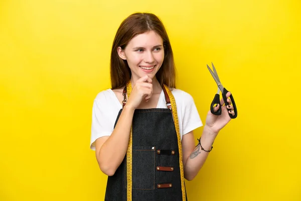 Young Seamstress English Woman Isolated Yellow Background Looking Side Smiling — Stock Photo, Image