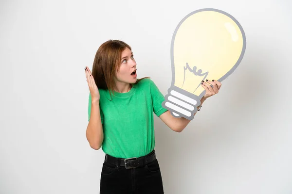 Young English Woman Isolated White Background Holding Bulb Icon Surprised — Stock Fotó
