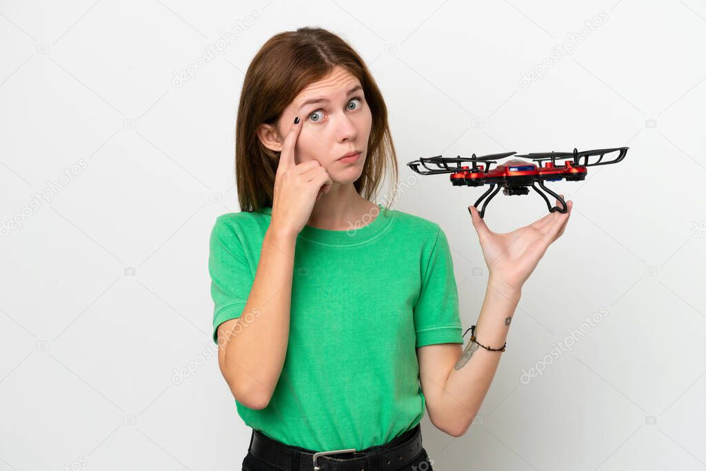 Young English woman holding a drone isolated on white background thinking an idea