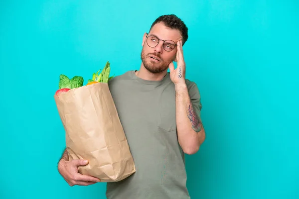 Young Brazilian Man Holding Grocery Shopping Bag Isolated Blue Background — 图库照片