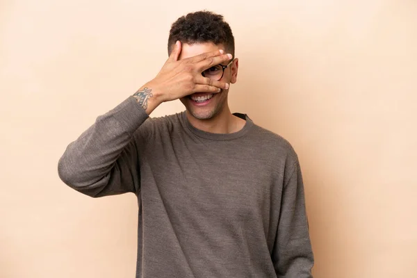 Young Brazilian Man Isolated Beige Background Covering Eyes Hands Smiling — Foto Stock