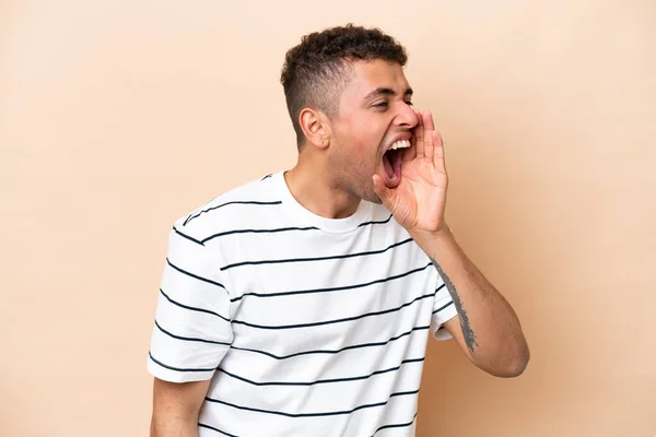 Young Brazilian Man Isolated Beige Background Shouting Mouth Wide Open — Stockfoto
