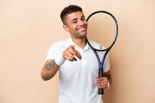 Young Brazilian Handsome Man Playing Tennis Isolated Beige Background Pointing — Stockfoto