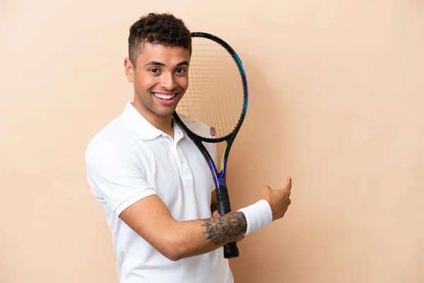 Young Brazilian Handsome Man Playing Tennis Isolated Beige Background Pointing — Stockfoto