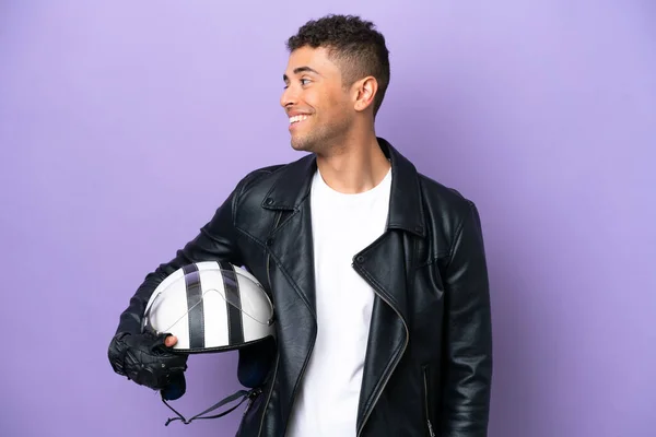 Young Brazilian Man Motorcycle Helmet Isolated Purple Background Looking Side — Stok fotoğraf