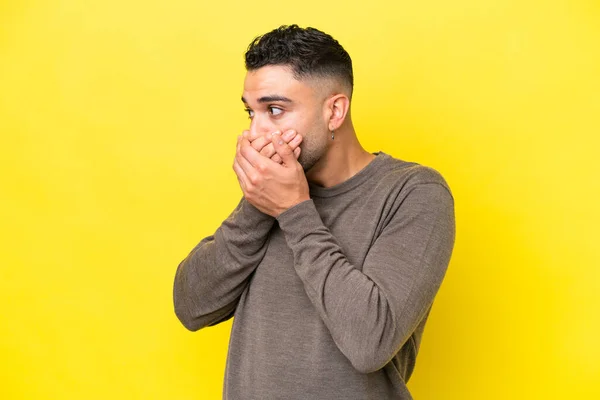 Young Arab Handsome Man Isolated Yellow Background Covering Mouth Looking — Stok fotoğraf