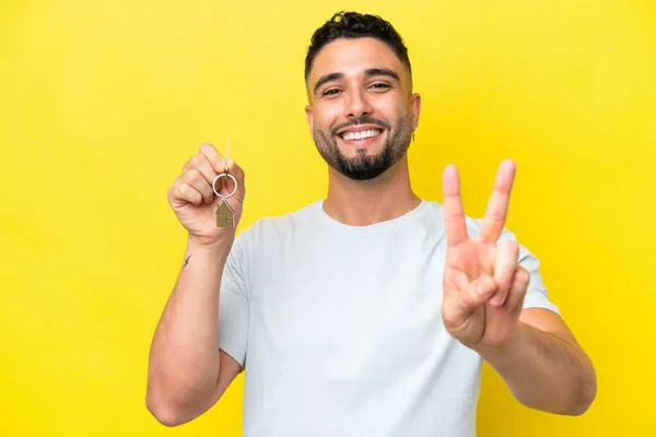 Young Arab Man Holding Home Keys Isolated Yellow Background Smiling — Stock fotografie