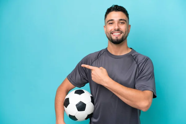 Young Arab Handsome Man Isolated Blue Background Soccer Ball Pointing — Foto Stock