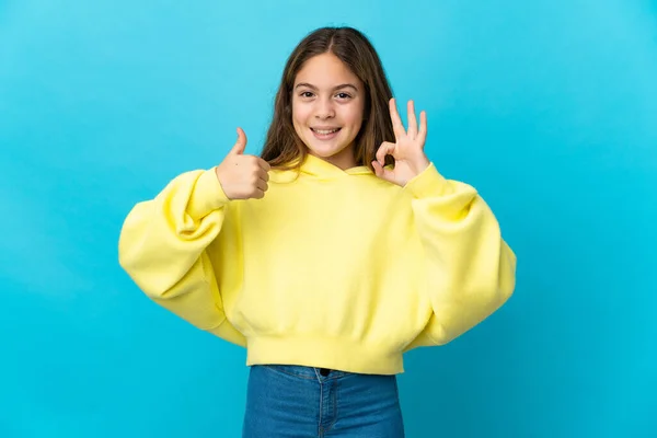 Little Girl Isolated Blue Background Showing Sign Thumb Gesture — Stockfoto
