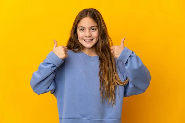 Child Isolated Yellow Background Giving Thumbs Gesture — ストック写真