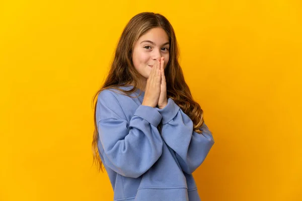 Child Isolated Yellow Background Keeps Palm Together Person Asks Something — Stockfoto