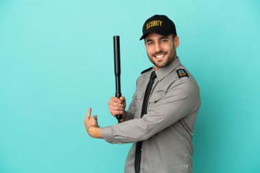 Genç güvenlik elemanı mavi arka planda izole edildi.