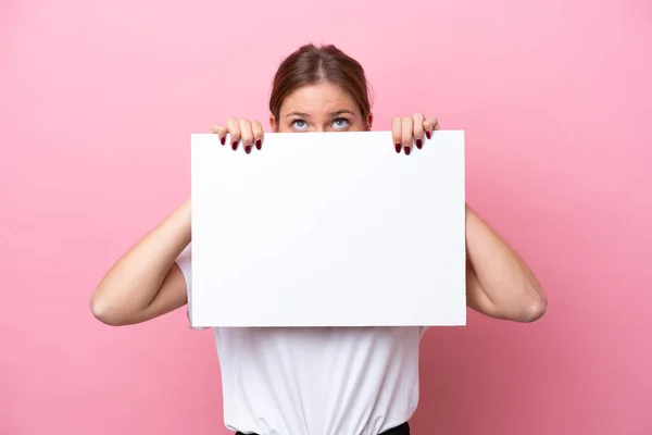Young Caucasian Woman Isolated Pink Background Holding Empty Placard Hiding — Stock Photo, Image