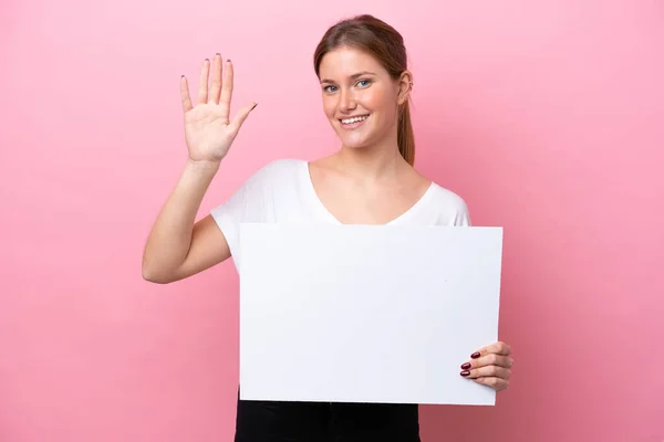 Young Caucasian Woman Isolated Pink Background Holding Empty Placard Saluting — Stock Photo, Image