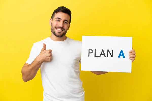 Young Handsome Caucasian Man Isolated Yellow Background Holding Placard Message — 图库照片