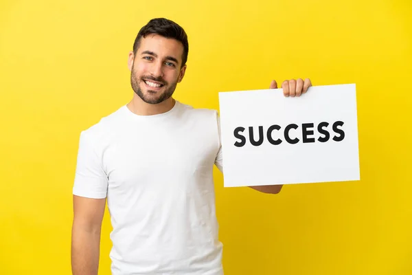 Young Handsome Caucasian Man Isolated Yellow Background Holding Placard Text — Stock Photo, Image