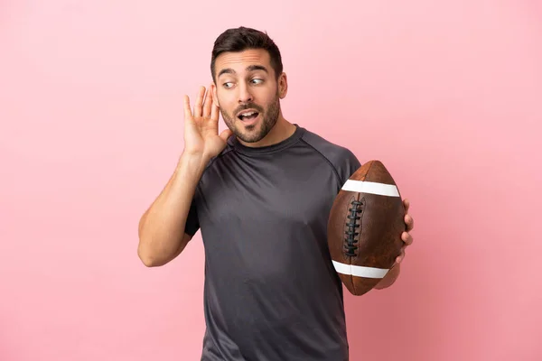 Young Caucasian Man Playing Rugby Isolated Pink Background Listening Something — Stock Photo, Image