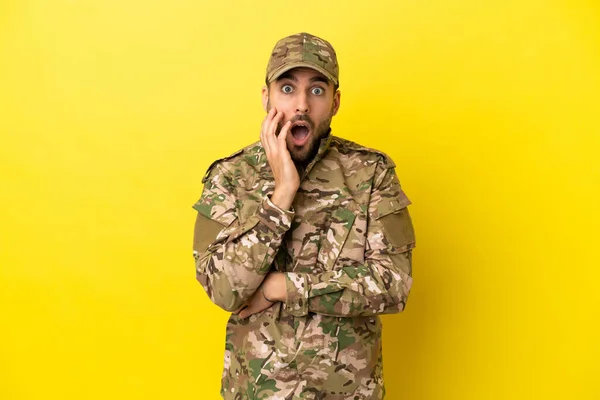Military Man Isolated Yellow Background Surprised Shocked While Looking Right — Foto Stock