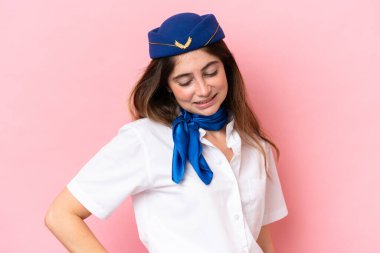 Airplane stewardess caucasian woman isolated on pink background suffering from backache for having made an effort