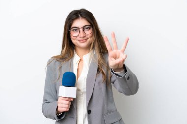 Young caucasian TV presenter woman isolated on white background happy and counting three with fingers