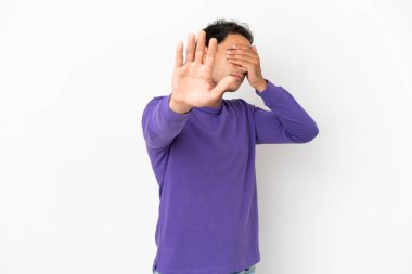Caucasian handsome man over isolated white background making stop gesture and covering face