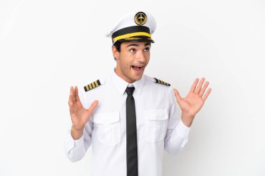 İzole edilmiş beyaz arka planda, şaşırmış yüz ifadesi olan uçak pilotu.