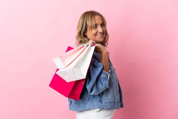 Middle Aged Blonde Woman Isolated Pink Background Holding Shopping Bags — Stock Photo, Image